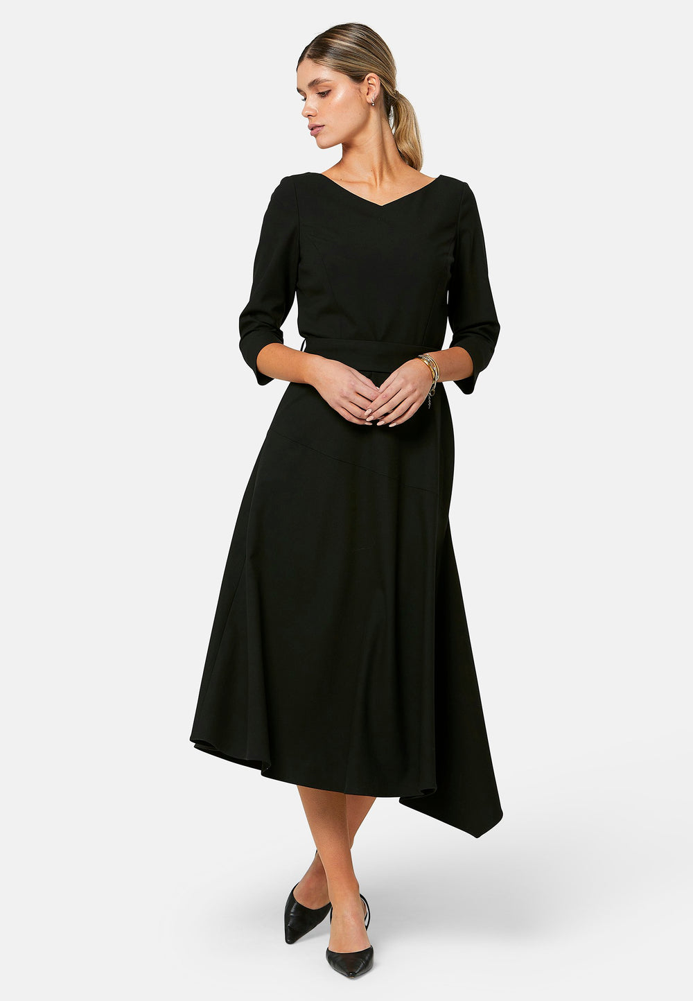 Odell, the perfect little black dress, designed in a fit and flare silhouette. Structured to the low waist, it features three-quarter sleeves, an asymmetrical hemline, and a detachable button-back belt. The flattering wide V-neckline makes it an elegant piece for any occasion.
