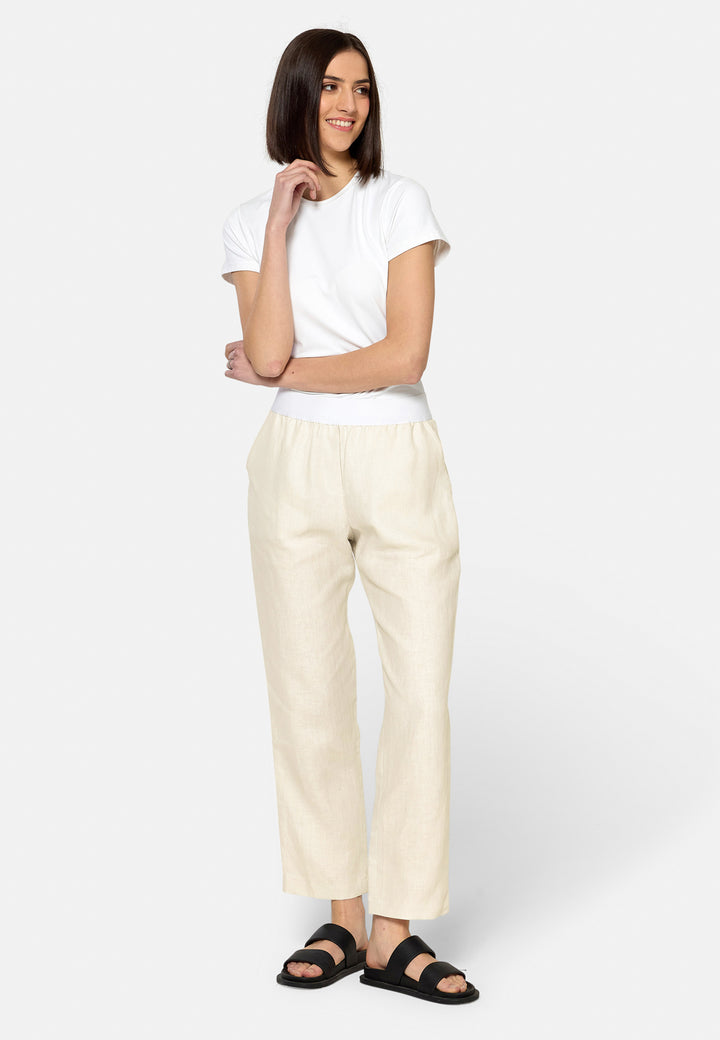 These relaxed-fit trousers in a buttermilk cream are crafted from breathable Irish linen, making them perfect for casual, everyday wear. Featuring an elasticated waistband and practical back pocket, they offer both comfort and functionality. Pair them with sandals, the Cassie jacket and a simple top for a laid-back, effortless look.