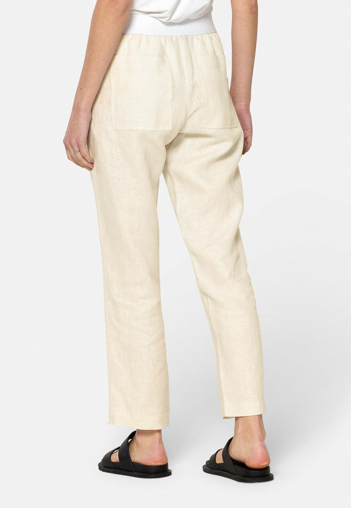 These relaxed-fit trousers in a buttermilk cream are crafted from breathable Irish linen, making them perfect for casual, everyday wear. Featuring an elasticated waistband and practical back pocket, they offer both comfort and functionality. Pair them with sandals, the Cassie jacket and a simple top for a laid-back, effortless look.