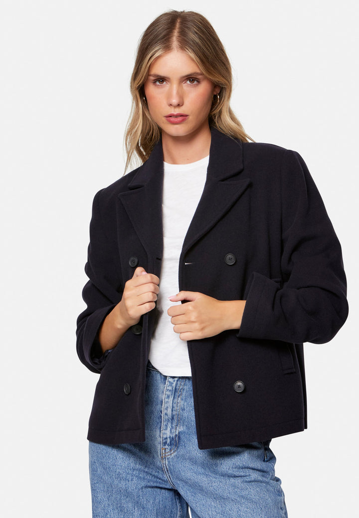 woman wearing double breast cashmere pea coat in navy