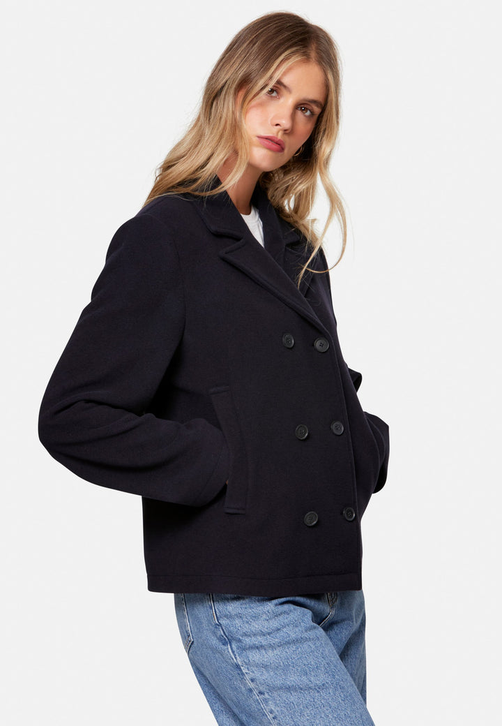 woman wearing double breast cashmere pea coat in navy