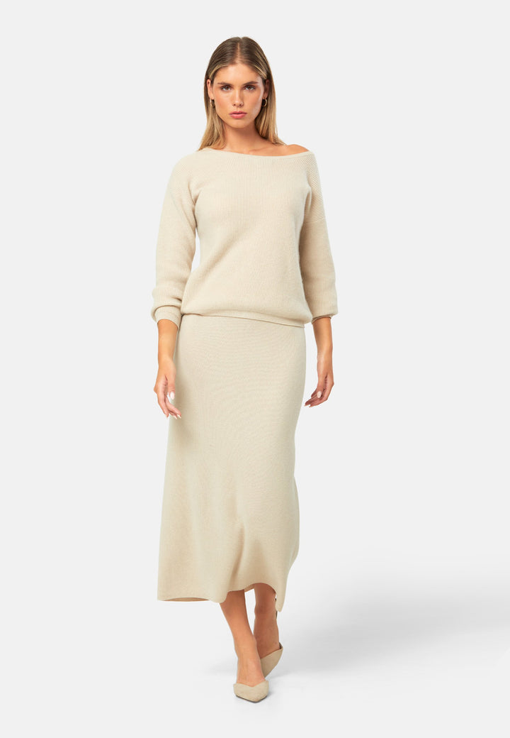Spun from pure cashmere in a smooth fine knit, this skirt pulls on with a soft waistband and falls to a fluid mid-calf hem that skims rather than clings. Minimal and quietly polished, it works 24/7: pair with the Marlena vest for a sleek twinset, switch to the boat-neck for off-shoulder ease, and ground with flats by day or heels after dark.