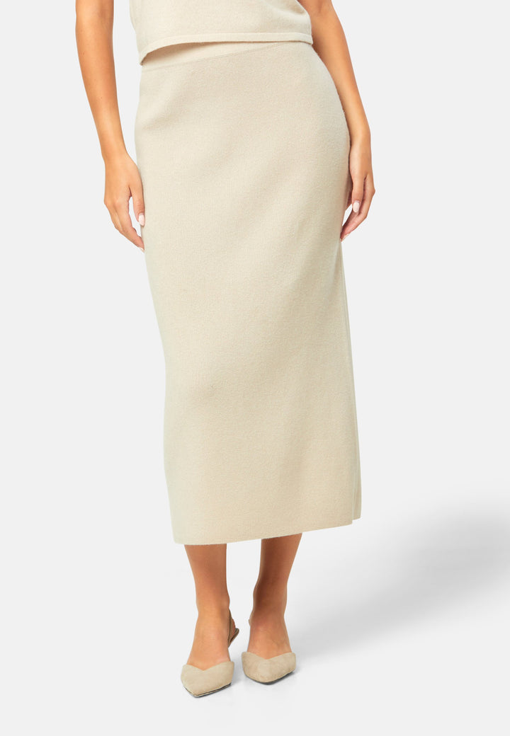 Spun from pure cashmere in a smooth fine knit, this skirt pulls on with a soft waistband and falls to a fluid mid-calf hem that skims rather than clings. Minimal and quietly polished, it works 24/7: pair with the Marlena vest for a sleek twinset, switch to the boat-neck for off-shoulder ease, and ground with flats by day or heels after dark.