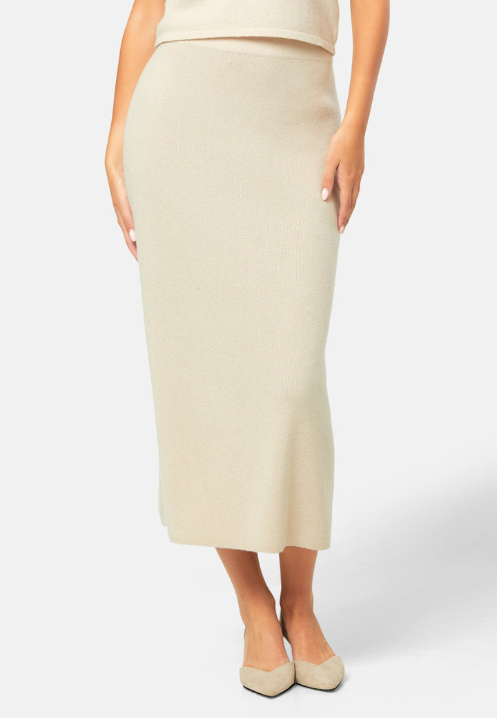Spun from pure cashmere in a smooth fine knit, this skirt pulls on with a soft waistband and falls to a fluid mid-calf hem that skims rather than clings. Minimal and quietly polished, it works 24/7: pair with the Marlena vest for a sleek twinset, switch to the boat-neck for off-shoulder ease, and ground with flats by day or heels after dark.