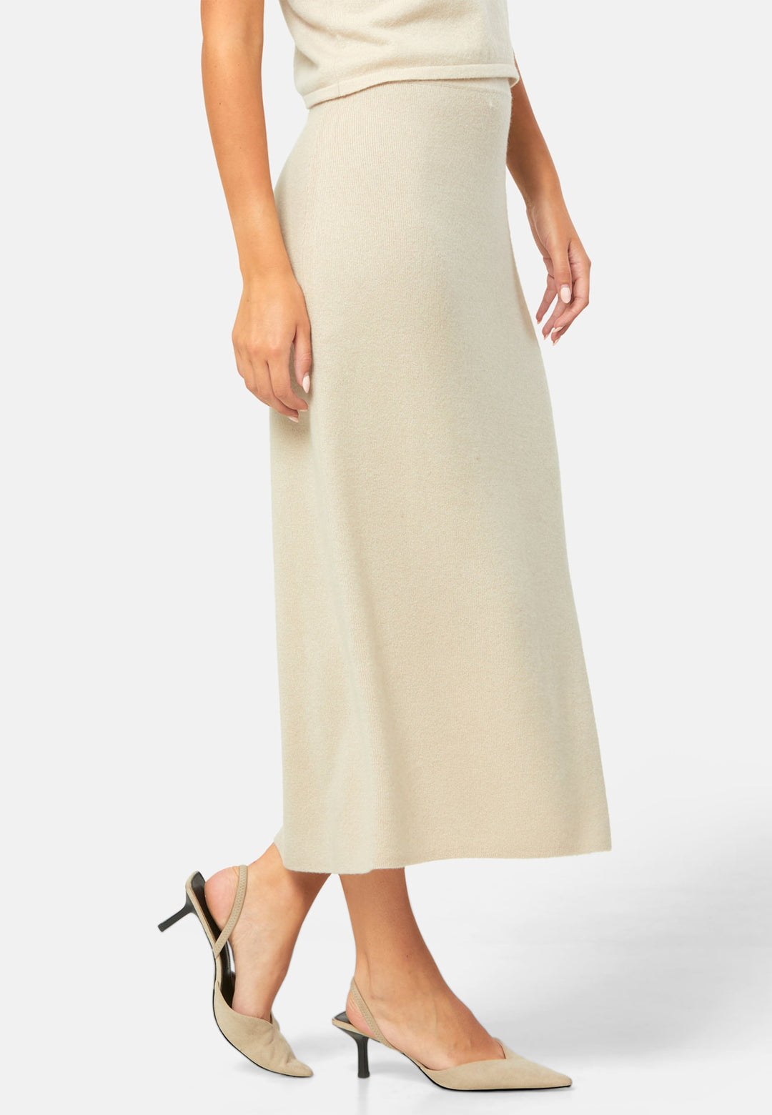 Spun from pure cashmere in a smooth fine knit, this skirt pulls on with a soft waistband and falls to a fluid mid-calf hem that skims rather than clings. Minimal and quietly polished, it works 24/7: pair with the Marlena vest for a sleek twinset, switch to the boat-neck for off-shoulder ease, and ground with flats by day or heels after dark.