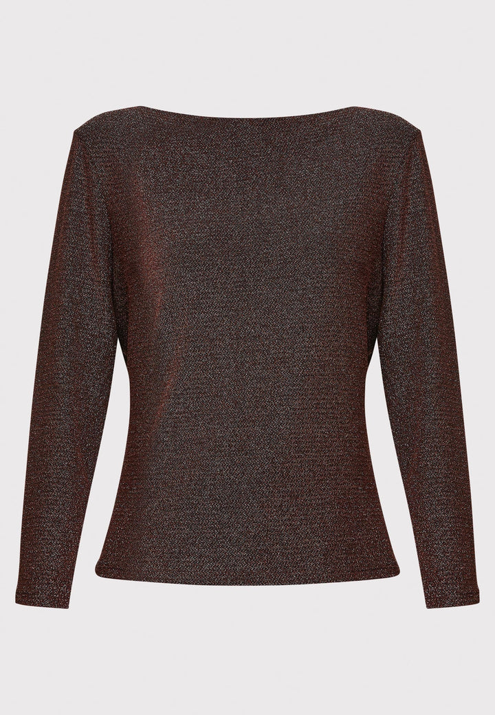 Introducing the Roxanne Copper Shimmer Top, an updated version of the beloved best-selling faux-wrap top. This season's design features a beautifully draped neckline for an elegant touch. With its hip-length cut and full-length sleeves, this top combines comfort and chic style effortlessly. Crafted from a black sparkly jersey fabric, it adds a touch of glamour to any outfit. Embrace the ultimate in comfortable chic with the Roxanne Copper Shimmer Top.