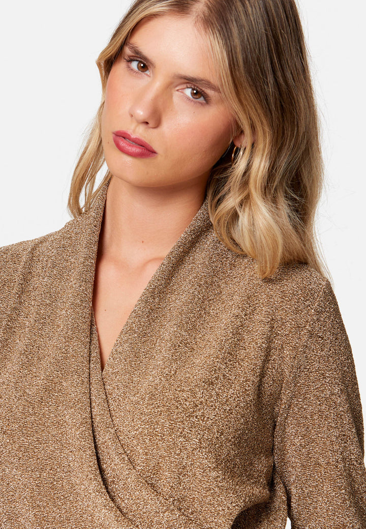 woman wearing faux wrap gold lurex top