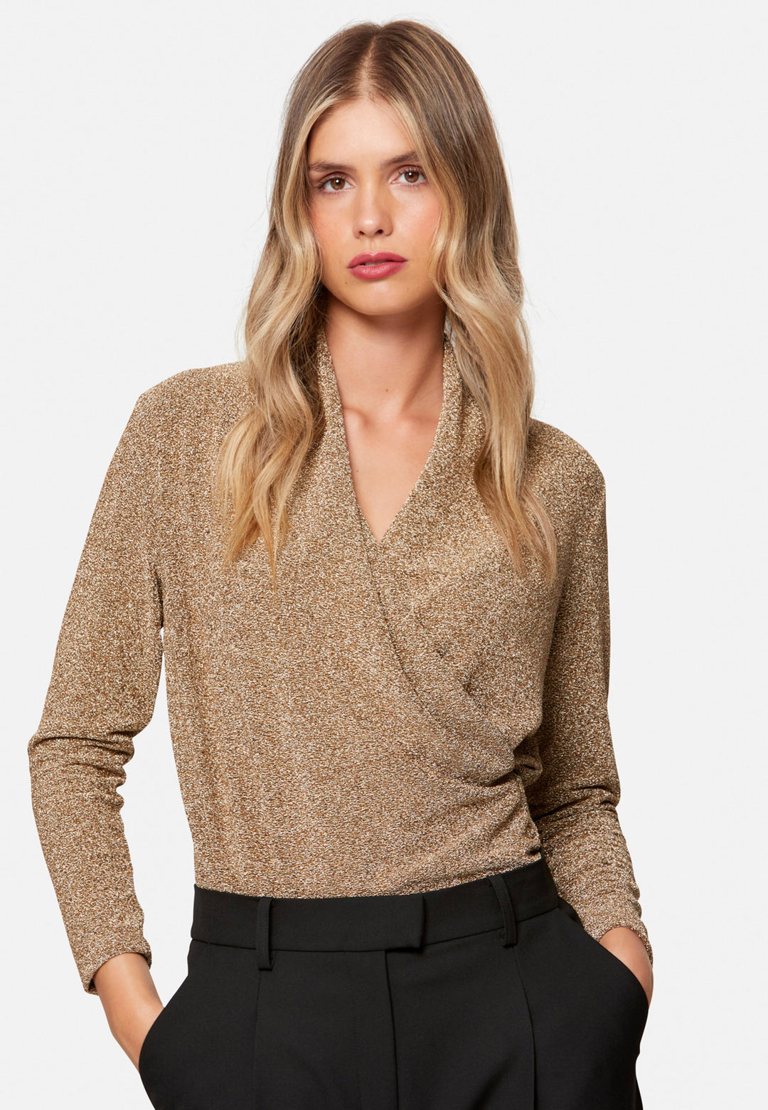 woman wearing faux wrap gold lurex top