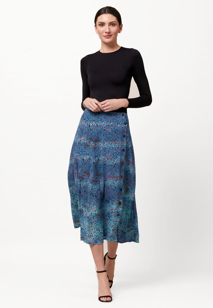 Opt for the saddie skirt to bring elegance to your everyday edit this season and beyond. Crafted in a fluid printed viscose crepe. This A-line silhouette is engineered with an off centered button through placket and elasticated back waist band. Relaxed elegance for everyday life. Pair it with a simple tee and the complimentary Cassie Navy boyfriend-blazer with trainers for a chic and contemporary look.