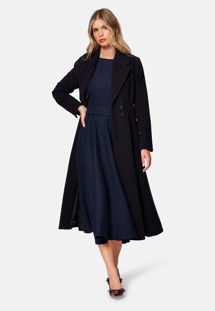 Embrace 50s glamour with Scarlett, a captivating coat crafted from a wool and cashmere melton blend. Designed with a double-breasted, fit-and-flare silhouette, it features a cinched waist, oversized shawl collar and practical side seam pockets. Perfect for winter weddings or any occasion where you desire a touch of glamour and warmth – combining style and functionality in one stunning piece.