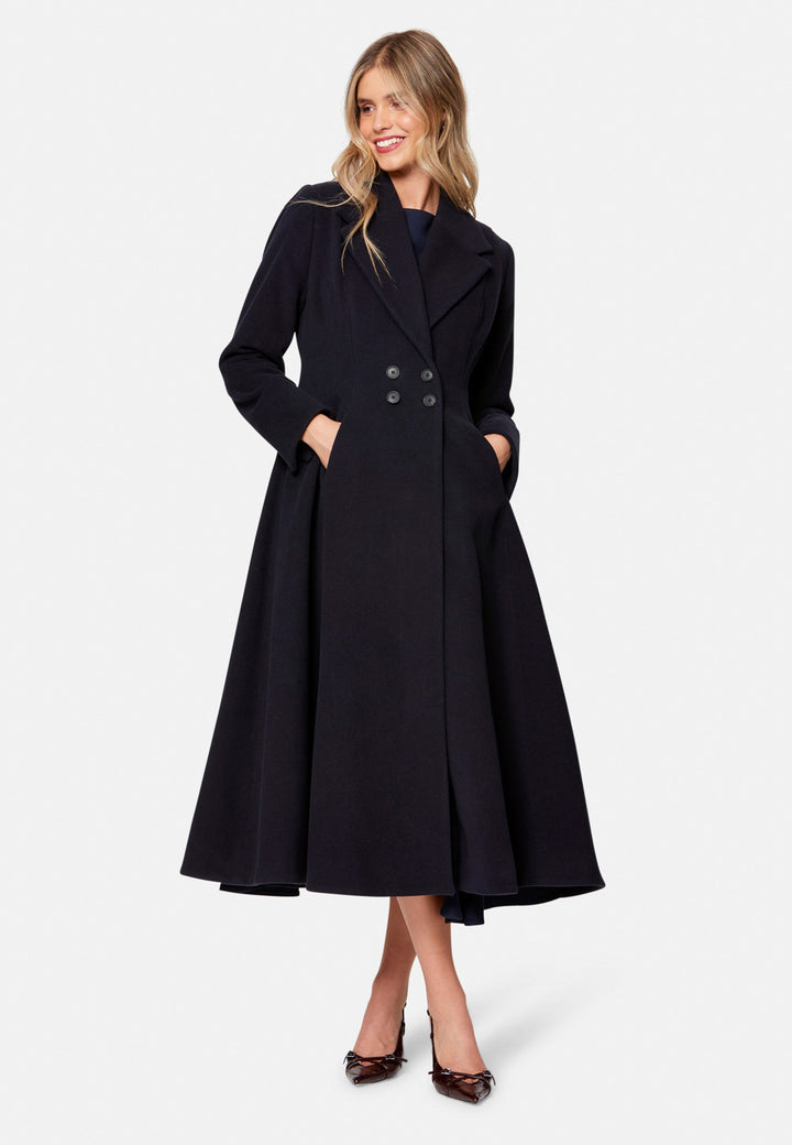 Embrace 50s glamour with Scarlett, a captivating coat crafted from a wool and cashmere melton blend. Designed with a double-breasted, fit-and-flare silhouette, it features a cinched waist, oversized shawl collar and practical side seam pockets. Perfect for winter weddings or any occasion where you desire a touch of glamour and warmth – combining style and functionality in one stunning piece.