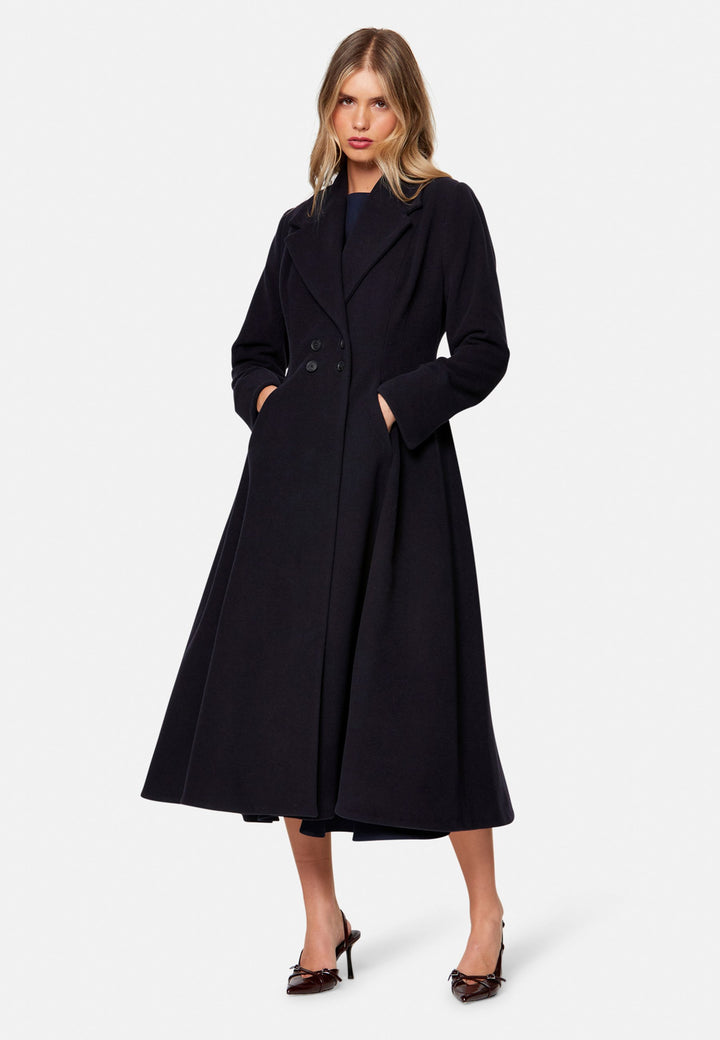 Embrace 50s glamour with Scarlett, a captivating coat crafted from a wool and cashmere melton blend. Designed with a double-breasted, fit-and-flare silhouette, it features a cinched waist, oversized shawl collar and practical side seam pockets. Perfect for winter weddings or any occasion where you desire a touch of glamour and warmth – combining style and functionality in one stunning piece.
