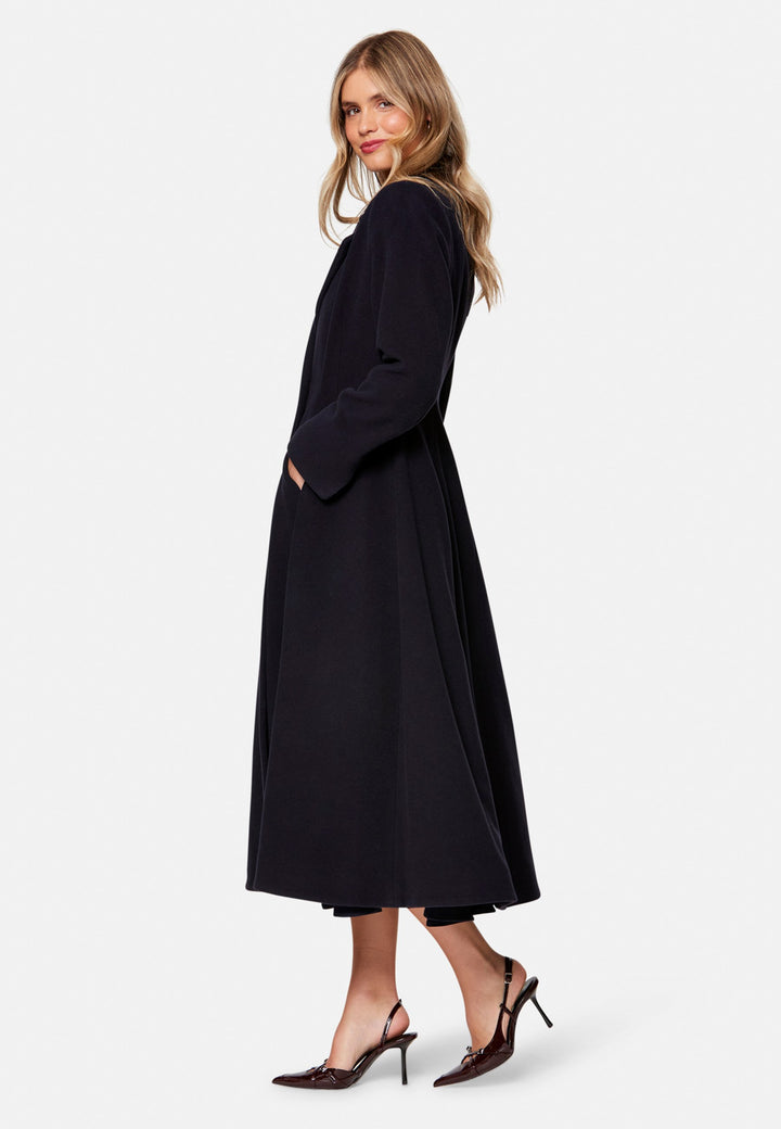 Embrace 50s glamour with Scarlett, a captivating coat crafted from a wool and cashmere melton blend. Designed with a double-breasted, fit-and-flare silhouette, it features a cinched waist, oversized shawl collar and practical side seam pockets. Perfect for winter weddings or any occasion where you desire a touch of glamour and warmth – combining style and functionality in one stunning piece.