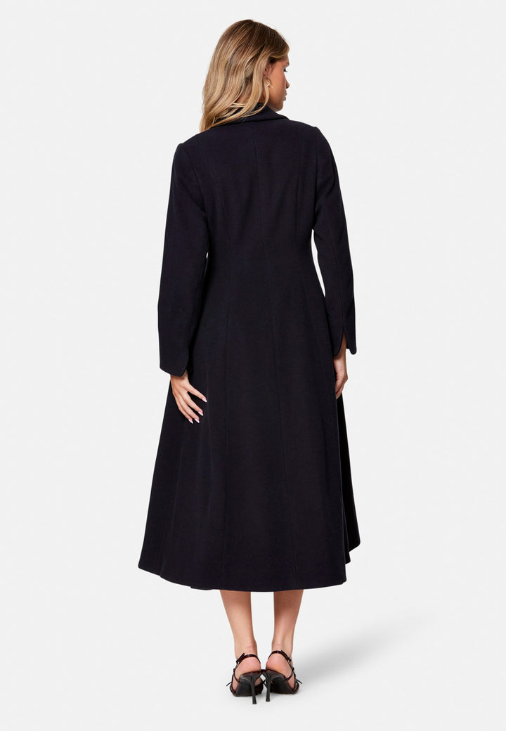 Embrace 50s glamour with Scarlett, a captivating coat crafted from a wool and cashmere melton blend. Designed with a double-breasted, fit-and-flare silhouette, it features a cinched waist, oversized shawl collar and practical side seam pockets. Perfect for winter weddings or any occasion where you desire a touch of glamour and warmth – combining style and functionality in one stunning piece.