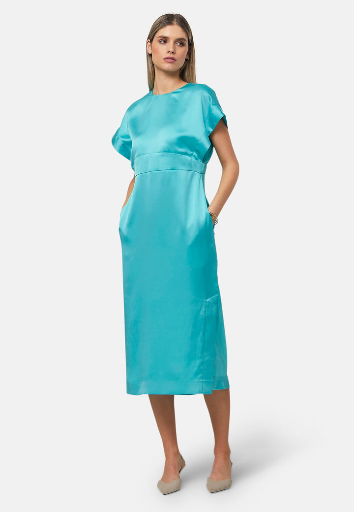 Elevate your wardrobe with the Shiv dress, a simple aqua midi dress in satin. Featuring dropped sleeves, a gathered back waist seam, and a side slit for ease of movement. The back has a keyhole detail with a button closure. Perfect for a summer wedding or afternoon luncheons.