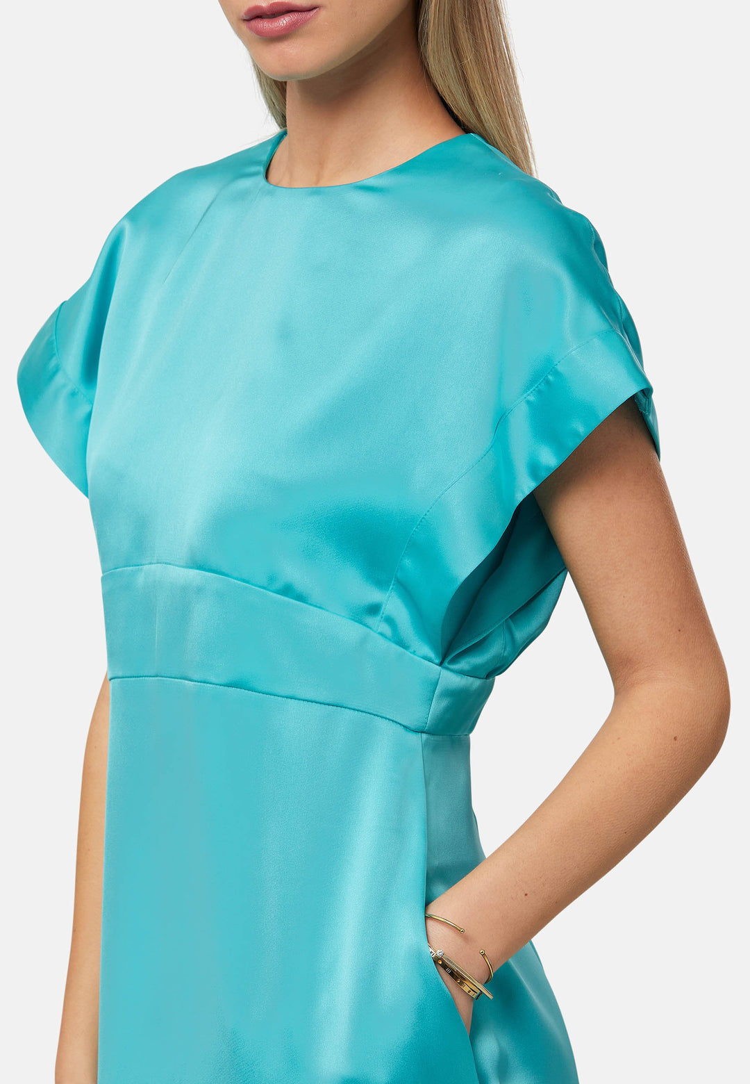 Elevate your wardrobe with the Shiv dress, a simple aqua midi dress in satin. Featuring dropped sleeves, a gathered back waist seam, and a side slit for ease of movement. The back has a keyhole detail with a button closure. Perfect for a summer wedding or afternoon luncheons.