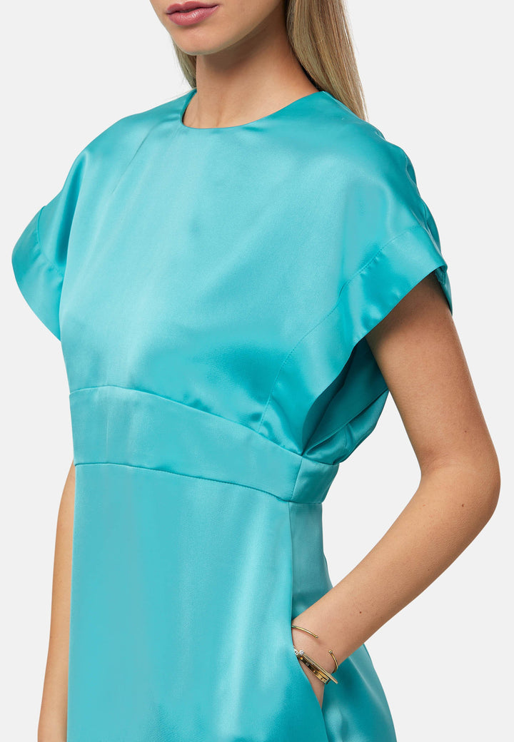 Elevate your wardrobe with the Shiv dress, a simple aqua midi dress in satin. Featuring dropped sleeves, a gathered back waist seam, and a side slit for ease of movement. The back has a keyhole detail with a button closure. Perfect for a summer wedding or afternoon luncheons.