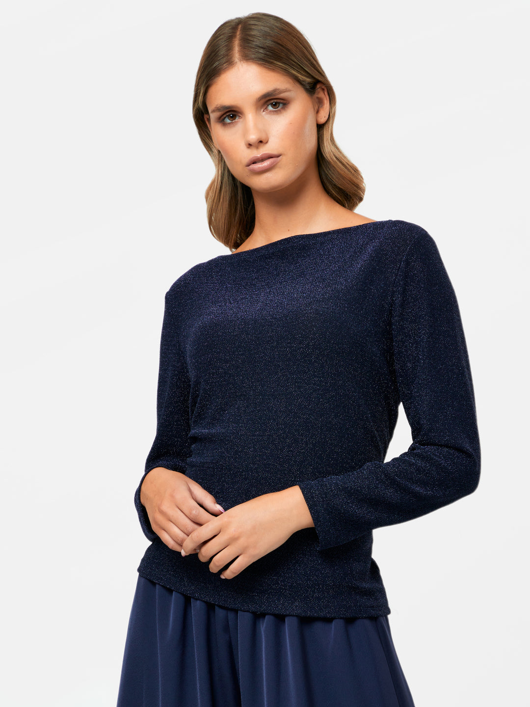 Introducing the Teagan Midnight Shimmer Top, a sophisticated boat neck blouse crafted from exquisite navy jersey with a touch of glamour. Helen effortlessly showcases its timeless elegance by pairing it with the Imogen Navy Palazzo Pants. Whether you're heading out for a night on the town or attending a professional event, this versatile and refined staple is perfect for any occasion.