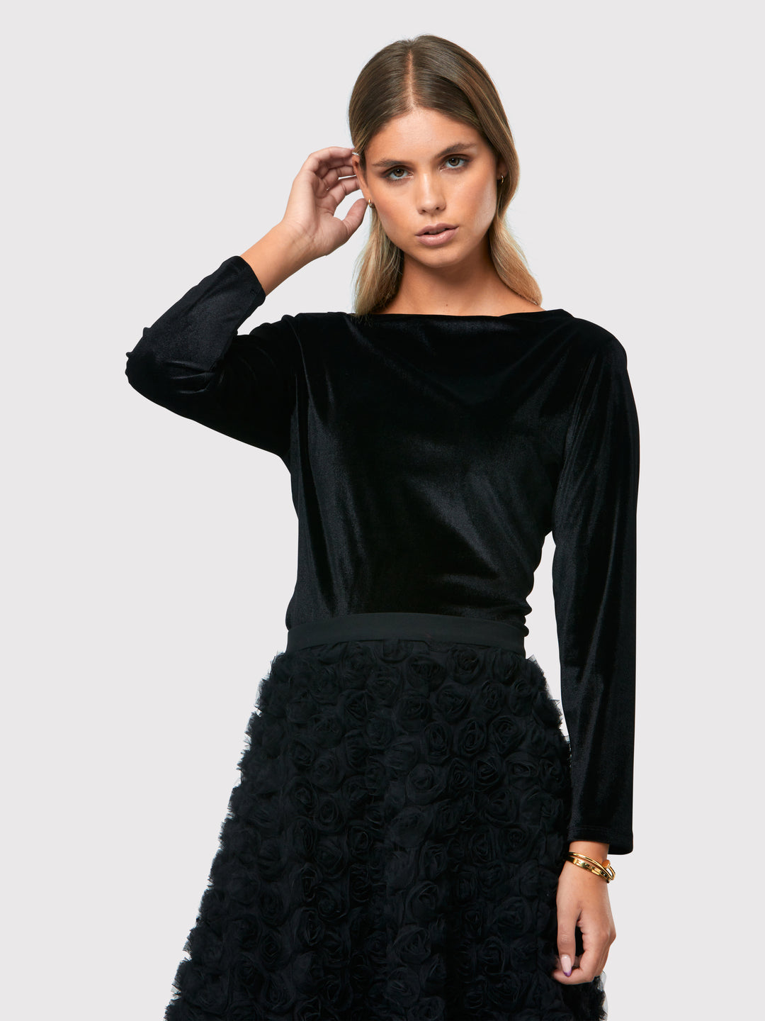 Teagan Black Velvet Top, a refined and stylish boat neck blouse that exudes sophistication. Crafted from sumptuous black stretch velvet, this top radiates opulence and elegance. Its timeless design makes it a versatile piece that can be effortlessly paired with various seperates.