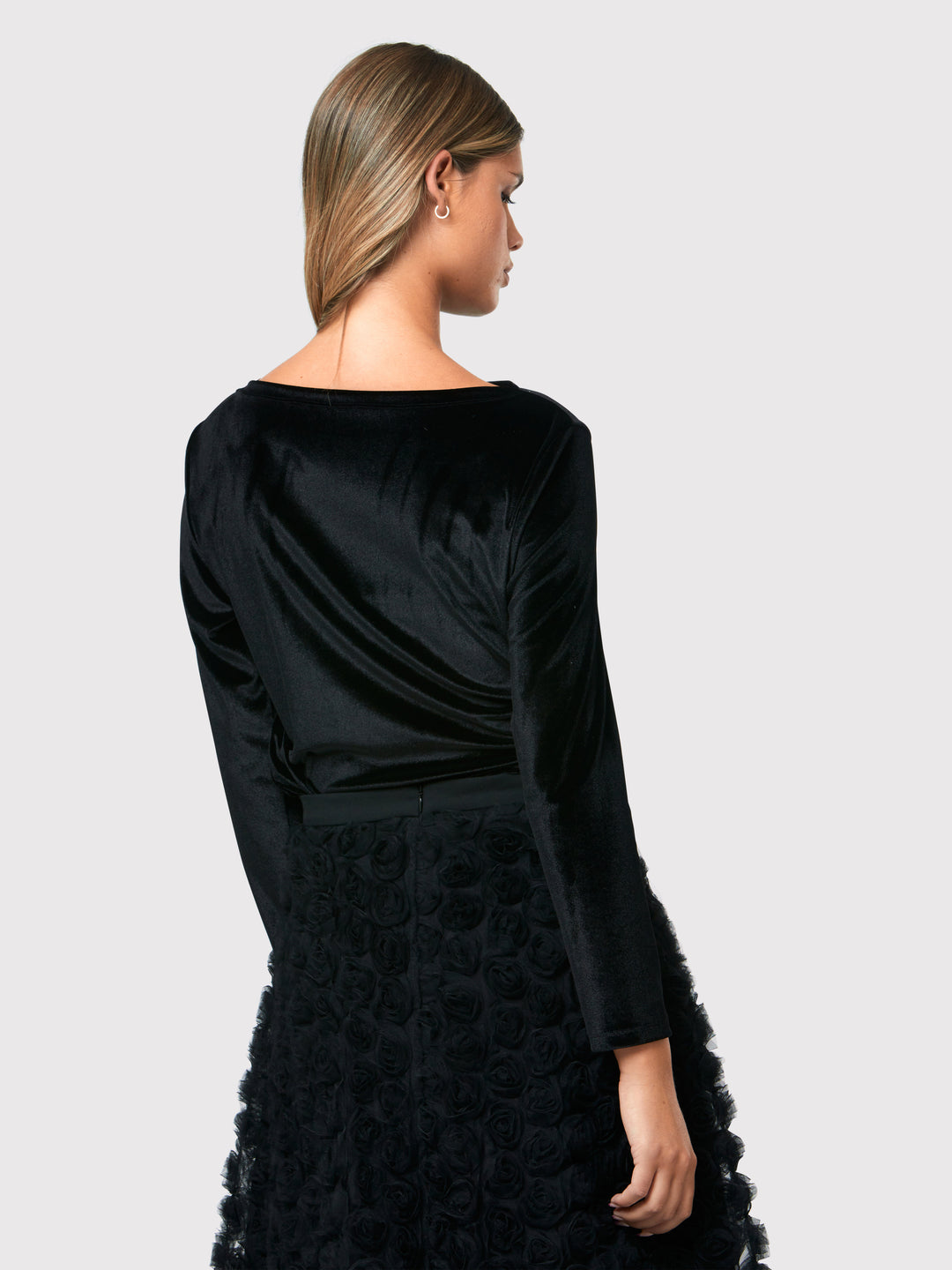 Teagan Black Velvet Top, a refined and stylish boat neck blouse that exudes sophistication. Crafted from sumptuous black stretch velvet, this top radiates opulence and elegance. Its timeless design makes it a versatile piece that can be effortlessly paired with various seperates.