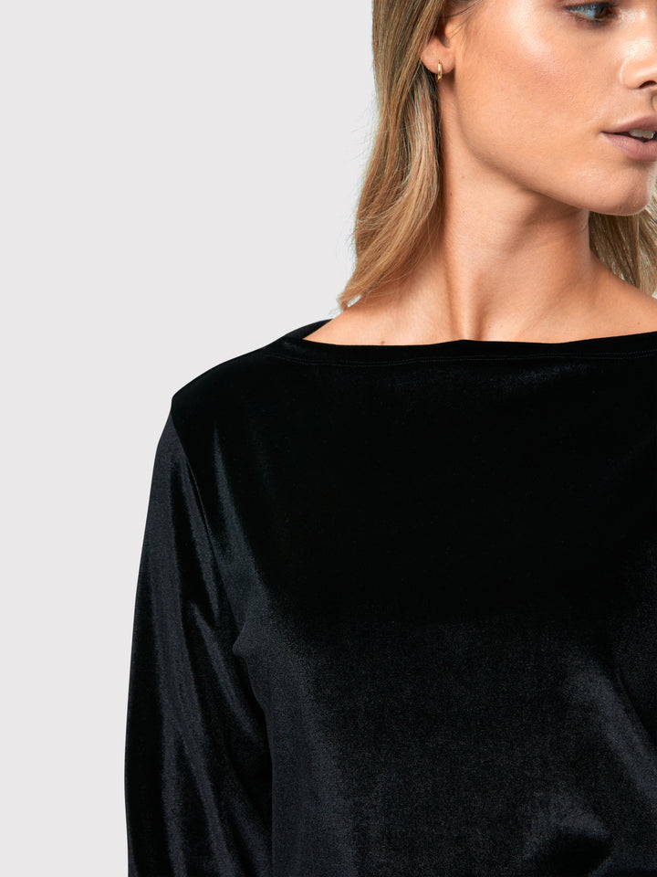 Teagan Black Velvet Top, a refined and stylish boat neck blouse that exudes sophistication. Crafted from sumptuous black stretch velvet, this top radiates opulence and elegance. Its timeless design makes it a versatile piece that can be effortlessly paired with various seperates.