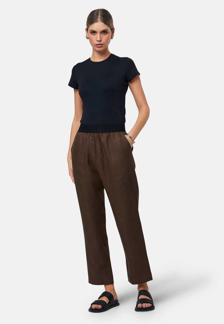 These relaxed-fit trousers in a rich brown hue are crafted from breathable Irish linen, making them perfect for casual, everyday wear. Featuring an elasticated waistband and practical back pocket, they offer both comfort and functionality. Pair them with sandals, the Cassie jacket and a simple top for a laid-back, effortless look.