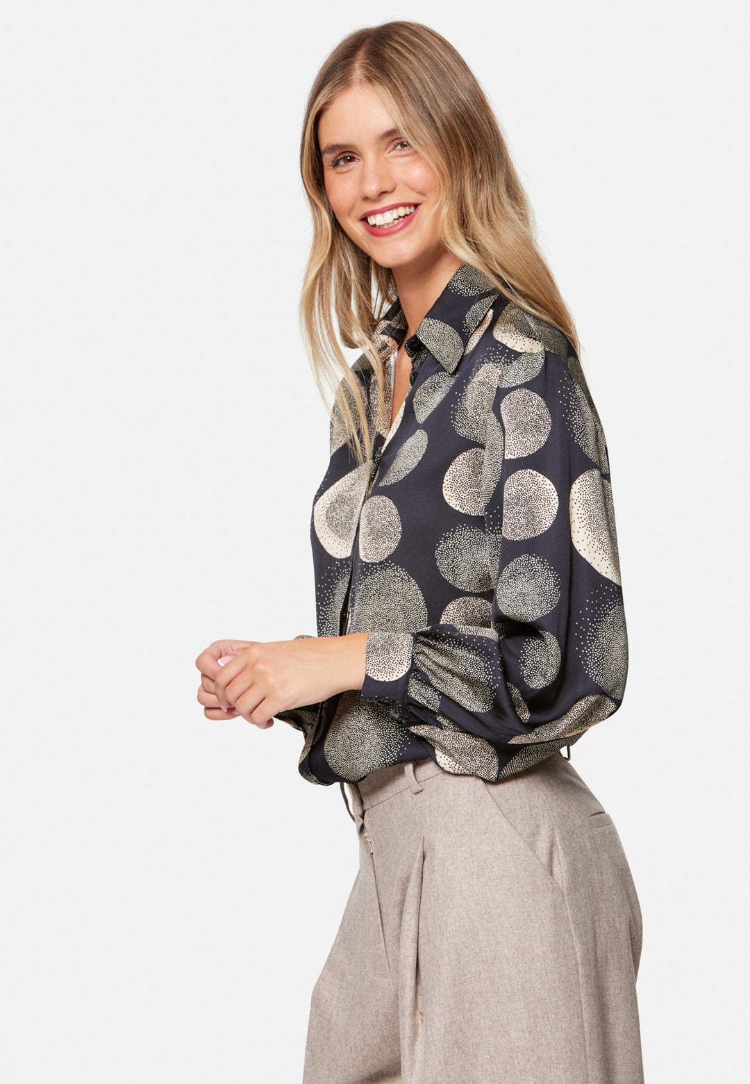 woman wearing printed navy and ivory shirt with wool pant