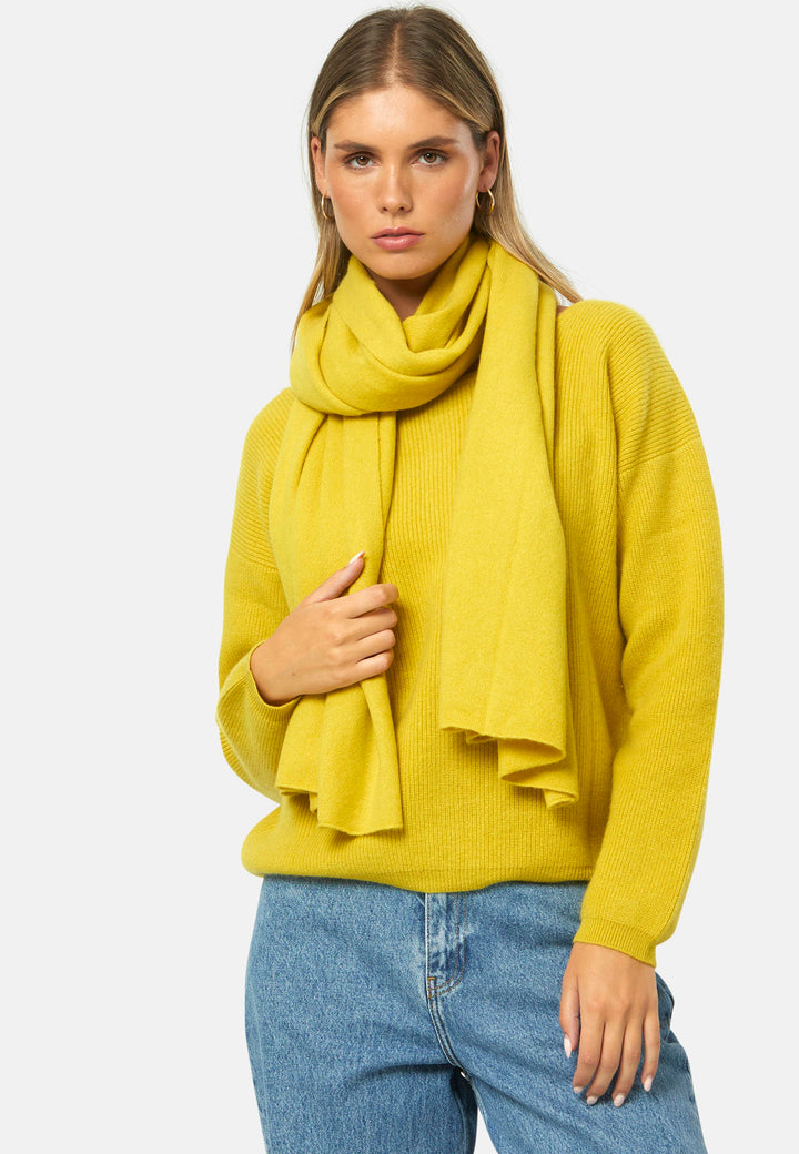 Knitted in pure cashmere with a soft handle, this generously cut wrap drapes fluidly. Loop, wrap or wear as a shoulder cover-up. It brings instant lift to denim days and casual outings. In vivid yellow ochre, it brightens winter neutrals; throw over a tailored coat or style with the coordinating knitwear for a cosy monotone look.