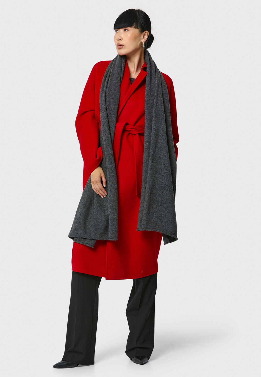 Introducing the Zola Cherry Red Cashmere Coat, a luxurious blend of cashmere and wool. This unlined coat features an oversized silhouette with patch pockets and a detachable belt. The dropped sleeves and tailor pick stitch finish add a touch of sophistication. Complete with a traditional collar and revere, it's a statement piece for your winter wardrobe.