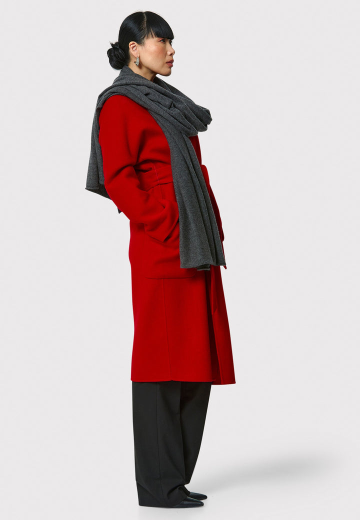 Introducing the Zola Cherry Red Cashmere Coat, a luxurious blend of cashmere and wool. This unlined coat features an oversized silhouette with patch pockets and a detachable belt. The dropped sleeves and tailor pick stitch finish add a touch of sophistication. Complete with a traditional collar and revere, it's a statement piece for your winter wardrobe.
