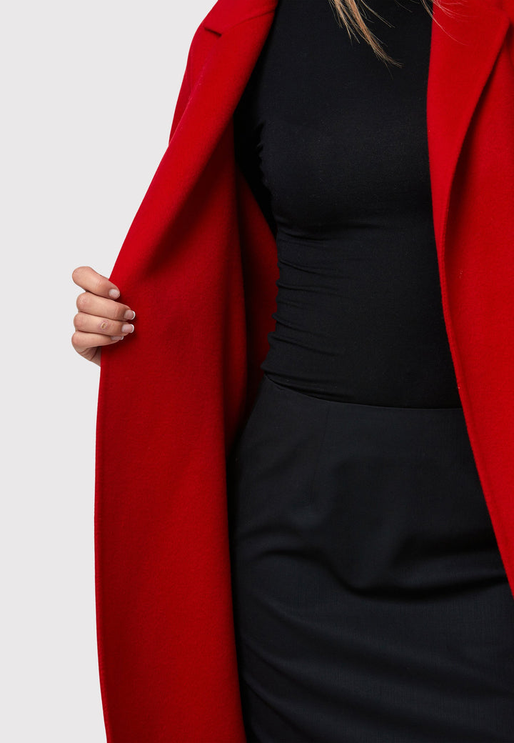 Introducing the Zola Cherry Red Cashmere Coat, a luxurious blend of cashmere and wool. This unlined coat features an oversized silhouette with patch pockets and a detachable belt. The dropped sleeves and tailor pick stitch finish add a touch of sophistication. Complete with a traditional collar and revere, it's a statement piece for your winter wardrobe.