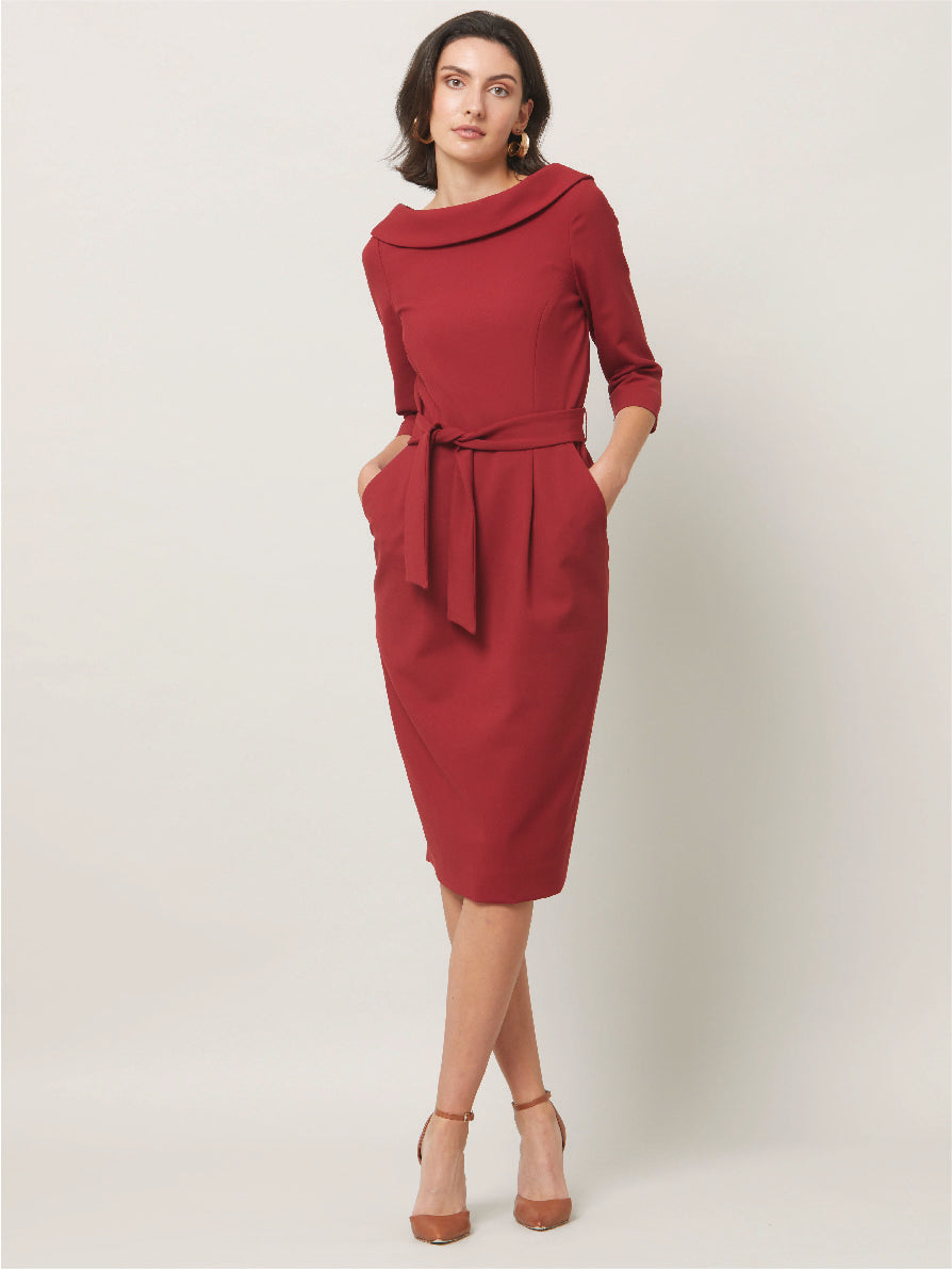 Dress for the occasion in the Mirren dress, inspired by hollywood glamour. Crafted in a sustainable, Russet tone, double crepe with a hint of stretch. features a velvet trimmed wide cowl neckline, body-skimming silhouette & a pencil skirt that falls below the knee. the detachable belt accentuates the waist. Sophisticated elegance for any occasion. Attending a winter wedding? Mother of the bride? Heading to the races? This is the dress for you.