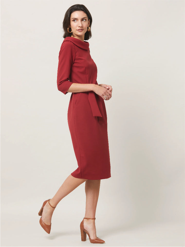 Dress for the occasion in the Mirren dress, inspired by hollywood glamour. Crafted in a sustainable, Russet tone, double crepe with a hint of stretch. features a velvet trimmed wide cowl neckline, body-skimming silhouette & a pencil skirt that falls below the knee. the detachable belt accentuates the waist. Sophisticated elegance for any occasion. Attending a winter wedding? Mother of the bride? Heading to the races? This is the dress for you.