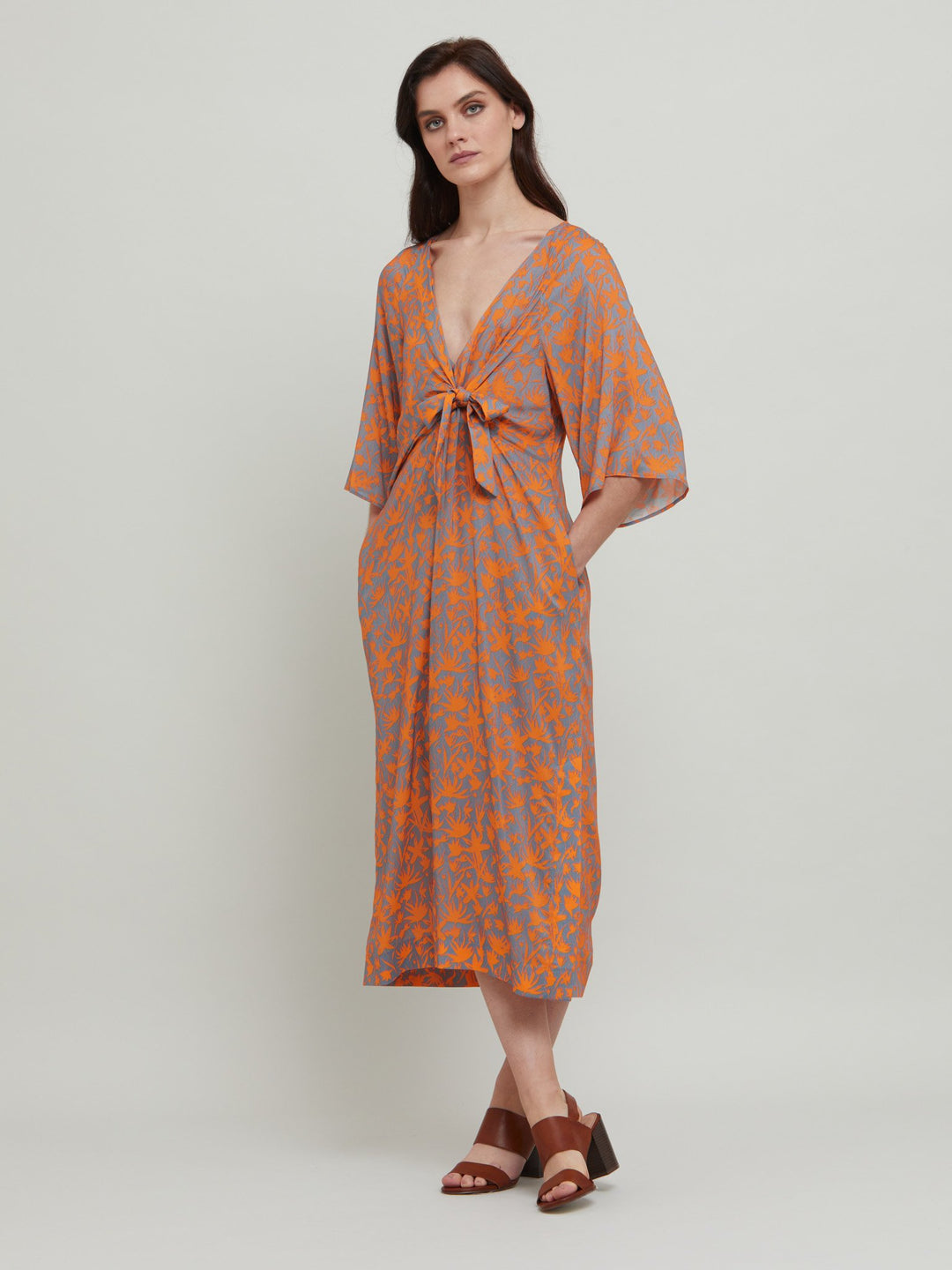 Introducing the Ailbhe, dress. This fun & easy fitting V-neck silhouette features front ties, slashed bodice, side seam pockets and falls to the mid-calf. Crafted in an adventurous and sophisticated rust & smoky blue printed breathable viscose.  Designed in Ireland by Helen McAlinden. Made in Europe. Free shipping to the EU & UK.
