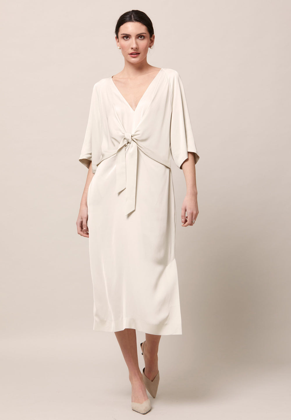 Bring out your inner Goddess in the Ailbhe dress. An elegantly draped silhouette. Cut from a Fluid Silver Birch satin viscose. Flattering front ties elevate this easy fit V-neck dress. Features handy Side seam pockets. Skirt falls to the mid-calf and side seam slit adds a sense of allure. Simply add heels and a clutch for a look that turns heads at any event. Classic Occasionwear, modernized.
