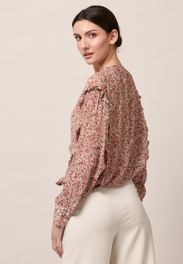 Give your everyday wardrobe an upgrade with the lauren jewel neck blouse. Cut in soft-touch silk blend crinkled georgette printed in feminine vintage inspired mini floral. A discreet ruffle runs from hem to hem over the shoulder. Lauren has been designed to add interest to the everyday.