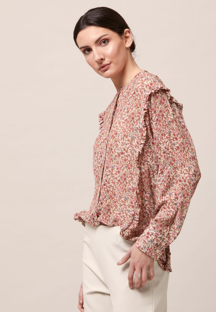 Give your everyday wardrobe an upgrade with the lauren jewel neck blouse. Cut in soft-touch silk blend crinkled georgette printed in feminine vintage inspired mini floral. A discreet ruffle runs from hem to hem over the shoulder. Lauren has been designed to add interest to the everyday.
