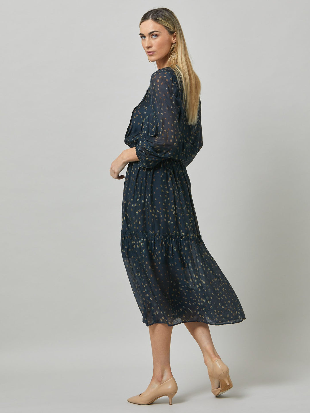 Bailey, elevate your game in this silk blend abstract print teal dress. Light and floaty with voluminous three-quarter-length sleeves. Feminine frills run from the shoulder to the waistline which falls into a bohemian tiered skirt.