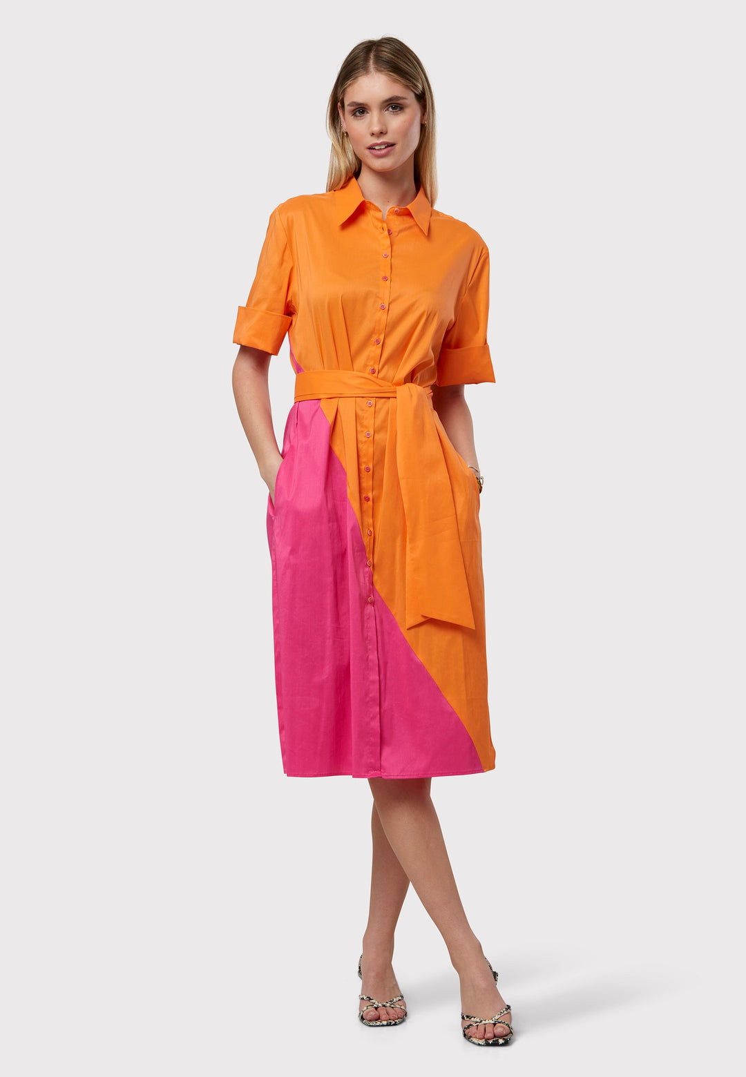 Introducing Bella, A bicoloured Shirt dress with a bold asymmetric panel, on both the front and back in vivid shades of orange and pink. Your go-to shirt dress. Crafted with a sleek edge, this dress boasts a detachable belt that cinches the waist. The relaxed silhouette drapes over the hips with practical side seam pockets.