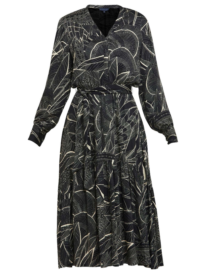 Beverly, an everyday dress. Crafted in a fluid, cream on black, botanical print viscose. A simple style with a V-neck button down bodice, handy pockets, elasticated waist & matching belt. Dress offers voluminous sleeves & a centre front slit on a fluid tiered skirt which falls to the mid-calf. 