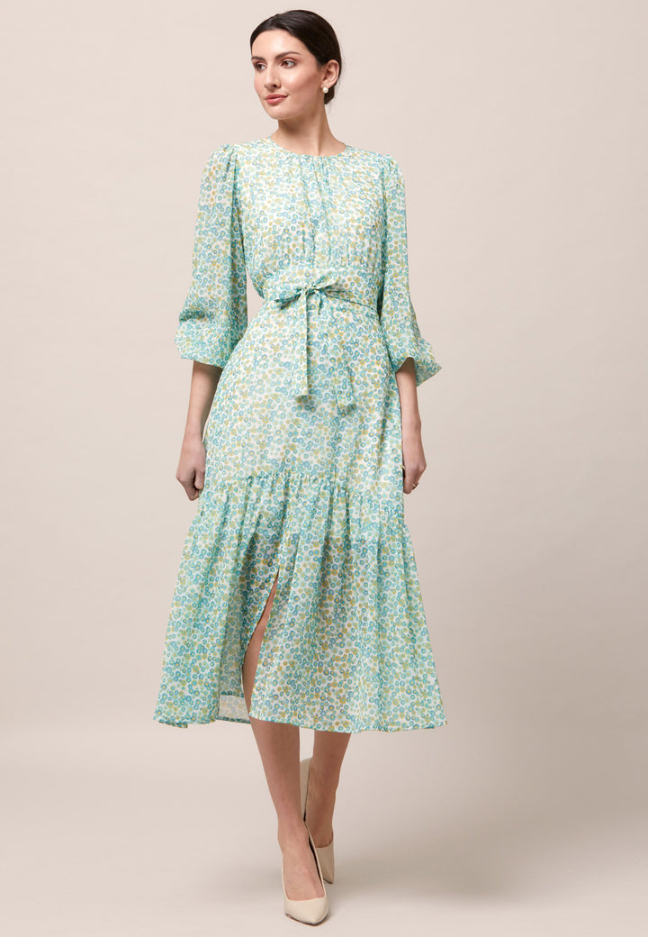 Opt for the Bev dress in a nuanced print to bring elegance to your everyday edit this season and beyond. Crafted in a sweeping midi-silhouette. The design is rooted in simplicity with a fit and softly flare skirt. Engineered Jewel neckline in this dress is accentuated with soft gathers. Waist is accentuated with a soft belt around the midriff for a customisable look that cinches the profile. The belt can be tied in the front or the back for added versatility. 