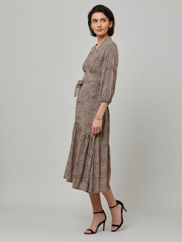 Beverly, the ultimate transeasonal day dress. This statement piece features a cross over V-neck detail, a flattering back waist tie, voluminous sleeves and front slit. Crafted in a viscose crepe in classic animal print.