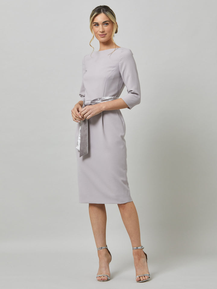 Caroline, the perfect desk-to-dinner dress in a feminine champagne tone. The fabric falls softly over the hips. this slash neck dress falls below the knee & pockets lend a sense of ease. Crafted luxe tricotine with a hint of stretch which ensures comfort & fit. Style with or without the matching velvet belt.