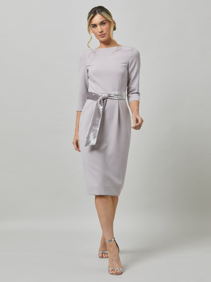 Caroline, the perfect desk-to-dinner dress in a feminine champagne tone. The fabric falls softly over the hips. this slash neck dress falls below the knee & pockets lend a sense of ease. Crafted luxe tricotine with a hint of stretch which ensures comfort & fit. Style with or without the matching velvet belt.