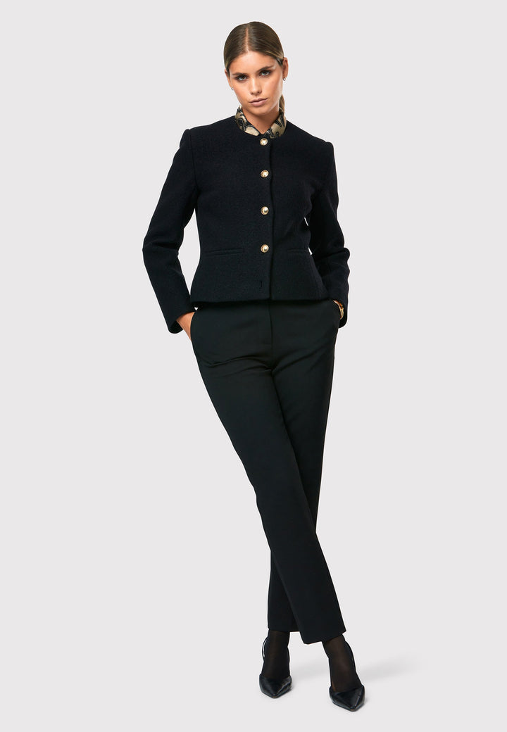 Introducing the Cassandra Black Jacket, a sleek and fitted piece crafted from a textured black boucle fabric. With its softly tailored silhouette, this jacket exudes modern elegance. The gold detail buttons add a touch of sophistication and elevate the overall aesthetic. Pair it effortlessly with the classic Jill pant for a timeless ensemble. The contemporary silhouette of the Cassandra Black Jacket is destined to become your go-to workwear icon for the season.