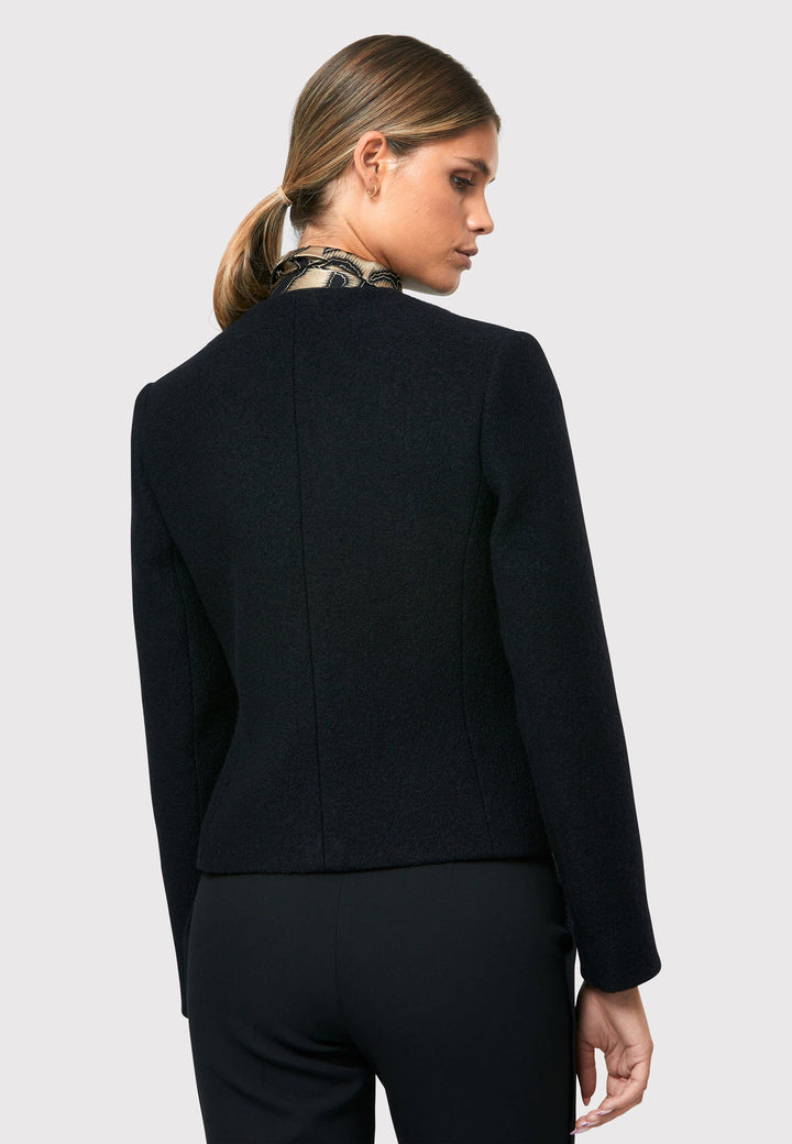 Introducing the Cassandra Black Jacket, a sleek and fitted piece crafted from a textured black boucle fabric. With its softly tailored silhouette, this jacket exudes modern elegance. The gold detail buttons add a touch of sophistication and elevate the overall aesthetic. Pair it effortlessly with the classic Jill pant for a timeless ensemble. The contemporary silhouette of the Cassandra Black Jacket is destined to become your go-to workwear icon for the season.