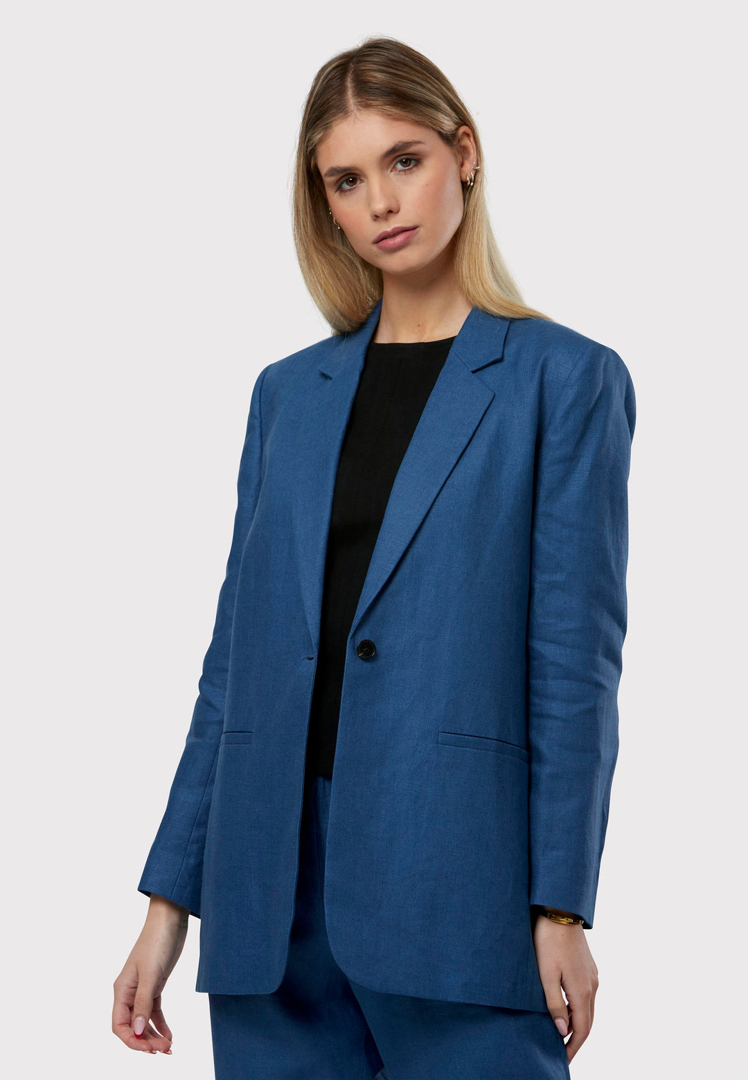 Cassie, the investment-worthy borage blue linen blazer. The epitome of summer sophistication. Minimalist styling accentuated by a single button fastening and an oversized, slightly boxy silhouette. Pair it effortlessly with a simple tee and the coordinating Vanessa pant, finished with trainers for a chic and contemporary ensemble.