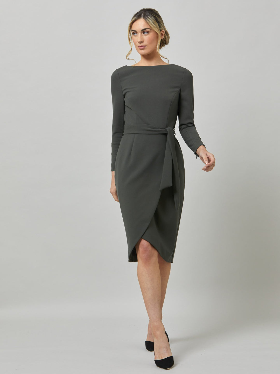 Celina, an elegant faux wrap pencil skirt dress in a smokey olive tone. Workwear redefined, the perfect desk to dinner dress. this body skimming silhouette falls below the knee and belted at the waist for a cinched profile, the ideal combination to accentuate the profile. Simply pair with heels for effortless elegance.