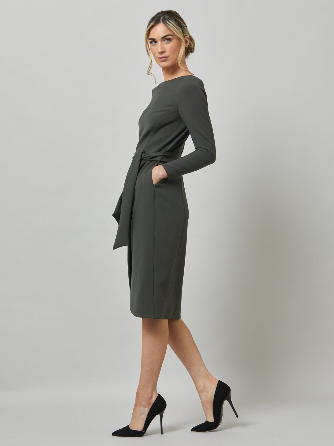 Celina, an elegant faux wrap pencil skirt dress in a smokey olive tone. Workwear redefined, the perfect desk to dinner dress. this body skimming silhouette falls below the knee and belted at the waist for a cinched profile, the ideal combination to accentuate the profile. Simply pair with heels for effortless elegance.