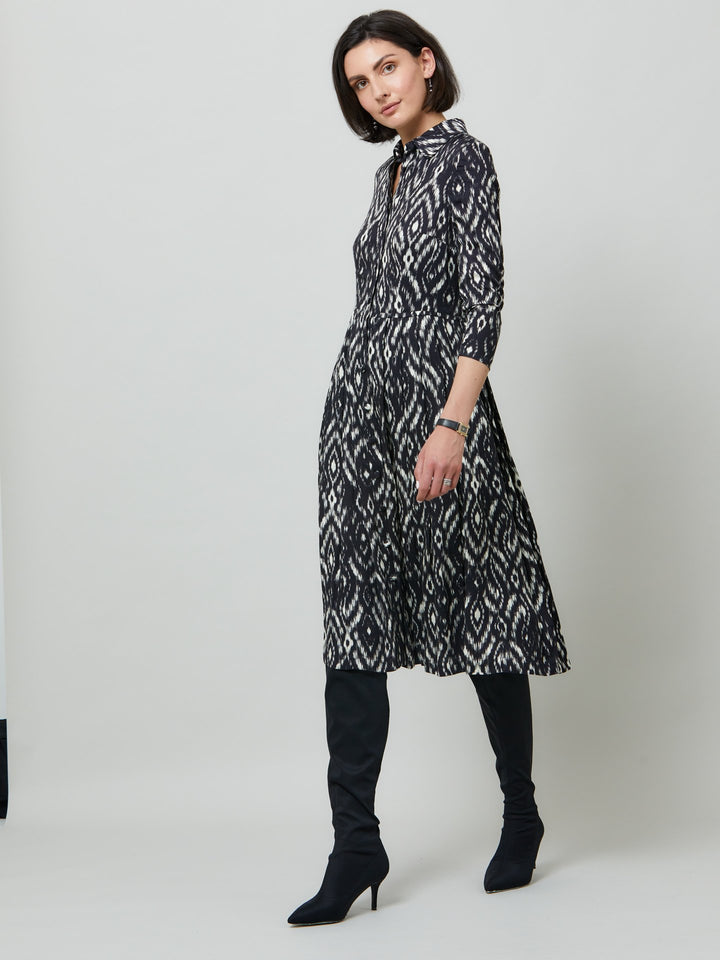 Sonia, a feminine take on the shirt dress. crafted in a fluid black and cream ikat printed viscose. A softly pleated skirt that falls to mid-calf. Wear to work, to the theatre, or out for cocktails with the girls. A simple yet feminine silhouette.